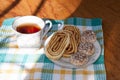 Tea and cakes with roll on a towel in the sunlight Royalty Free Stock Photo