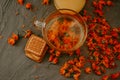 Tea with calendula flowers and biscuits. Transparent glass cup and saucer Royalty Free Stock Photo