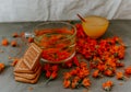 Tea with calendula flowers and biscuits. Transparent glass cup and saucer Royalty Free Stock Photo