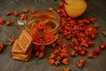 Tea with calendula flowers and biscuits. Transparent glass cup and saucer Royalty Free Stock Photo