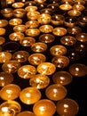 Tea candles in a row burning on black background Royalty Free Stock Photo