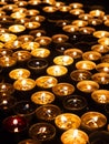 Tea candles in a row burning on black background Royalty Free Stock Photo