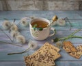 Tea in a ceramic mug with cereal liver on a wooden tray and balls of mature shoes for decorating and uplifting, side view Royalty Free Stock Photo