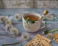 Tea in a ceramic mug with cereal liver on a wooden tray and balls of mature shoes for decoration and rustic style, side view Royalty Free Stock Photo