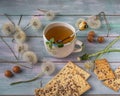 Tea in a ceramic mug with grain-cookies and caramel cookies on a wooden tray and balls of mature shoes for decoration and rustic Royalty Free Stock Photo