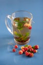 Tea on ceramic tiles with dust texture and reflection. Near scattered strawberries. Vertical. Royalty Free Stock Photo