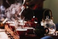 Tea ceremony. The man pours hot water from the teapot into the red chinese tea cup Royalty Free Stock Photo