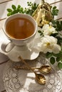 Tea in a china white cup and saucer, with white rose Royalty Free Stock Photo
