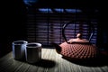 Tea concept. Japanese tea ceremony culture east beverage. Teapot and cups on table with bamboo leaves on sunset