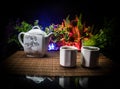 Tea concept. Japanese tea ceremony culture east beverage. Teapot and cups on table with bamboo leaves on sunset