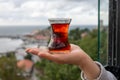 Tea cup armudas on woman hand, traditional Turkish tea. Turkish red aromatic tea in traditional authentic glass cup - armudu. Royalty Free Stock Photo