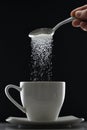 Tea cup or coffee and pouring sugar spoon Royalty Free Stock Photo