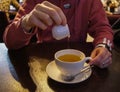 the tea cup, filled with a fragrant brew