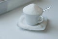 Tea cup full of white sugar Royalty Free Stock Photo