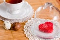 Tea cup with heart shaped biscuits. Sugar red biscuits. Royalty Free Stock Photo