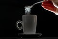 Tea cup and pouring sugar spoon Royalty Free Stock Photo