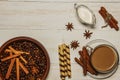 Tea in a cup with raspberry jam, cookies, croissants, cinnamon, anise, caramel sticks. On a white wooden table. Christmas composit Royalty Free Stock Photo