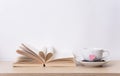 Tea cup with red heart on book shelf. Valentines day Royalty Free Stock Photo