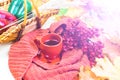 Tea Cup, red plaid, vegetables in a wicker basket, red Apple, green bell pepper, autumn maple leaves on a light wood background. S Royalty Free Stock Photo