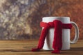 Tea cup of tea with red warm knitted scarf. Autumn, fall background. Cold and illnes season