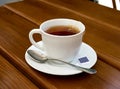 Tea, cup, spoon, wood, table Royalty Free Stock Photo