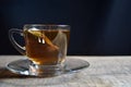 Tea cup with tea bag on old wood. Summer tea time Royalty Free Stock Photo