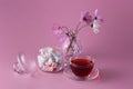 Tea cup with twisted colored marshmallow in jar