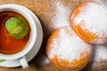 Tea cup with two sugar powdered buns