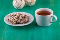 Tea in a cup and wafer tubules in a plate on Royalty Free Stock Photo