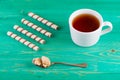 Tea in a cup and wafer tubules in a plate Royalty Free Stock Photo