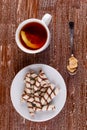 Tea in a cup and wafer tubules in a plate Royalty Free Stock Photo