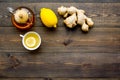 Tea for cure colds. Cup, teapot, ginger root and lemon on dark wooden background top view copy space Royalty Free Stock Photo