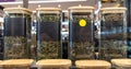 Tea of different varieties in glass jars stand in a row on a store shelf. Royalty Free Stock Photo