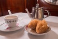 Tea & dim sum on a white table : Iron kettle,white tea cup, deep fried taro with chicken dumplings