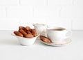 Tea and dried dates in a bowl on white background. Turkish sweets. Natural healthy food Royalty Free Stock Photo