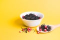 tea with dried strawberries in a white bowl, strawberry tea in a large wooden spoon