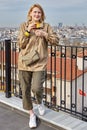 Tea drinking on roof of hotel overlooking cityscape of Istanbul,  young European woman stands with glass in her hands Royalty Free Stock Photo