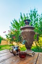 Tea drinking from a vintage samovar in garden Royalty Free Stock Photo