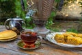 Tea drinking from a vintage samovar with oriental sweets Royalty Free Stock Photo