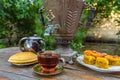 Tea drinking from a vintage samovar with oriental sweets Royalty Free Stock Photo