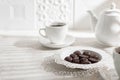Tea drinking. White teapot with cups and a set of chocolates Royalty Free Stock Photo