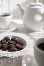 Tea drinking. White teapot with cups and a set of chocolates Royalty Free Stock Photo