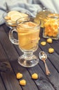 Tea with ginger and lemon in a glass cup and yellow sweets Royalty Free Stock Photo