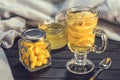 Tea with ginger and lemon in a glass cup and yellow sweets Royalty Free Stock Photo