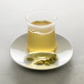 Tea glass with fresh made hot Cardamon tea and seed pods Royalty Free Stock Photo