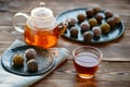 Tea in glass teapot, cup and energy balls