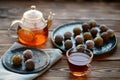 Tea in glass teapot, cup and energy balls
