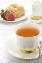 Tea with glazed cruller and strawberries Royalty Free Stock Photo