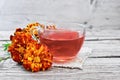 Tea herbal of marigolds in cup on burlap Royalty Free Stock Photo