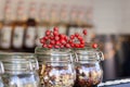 Tea jars on a table in a coffee shop with a berry decoration Royalty Free Stock Photo